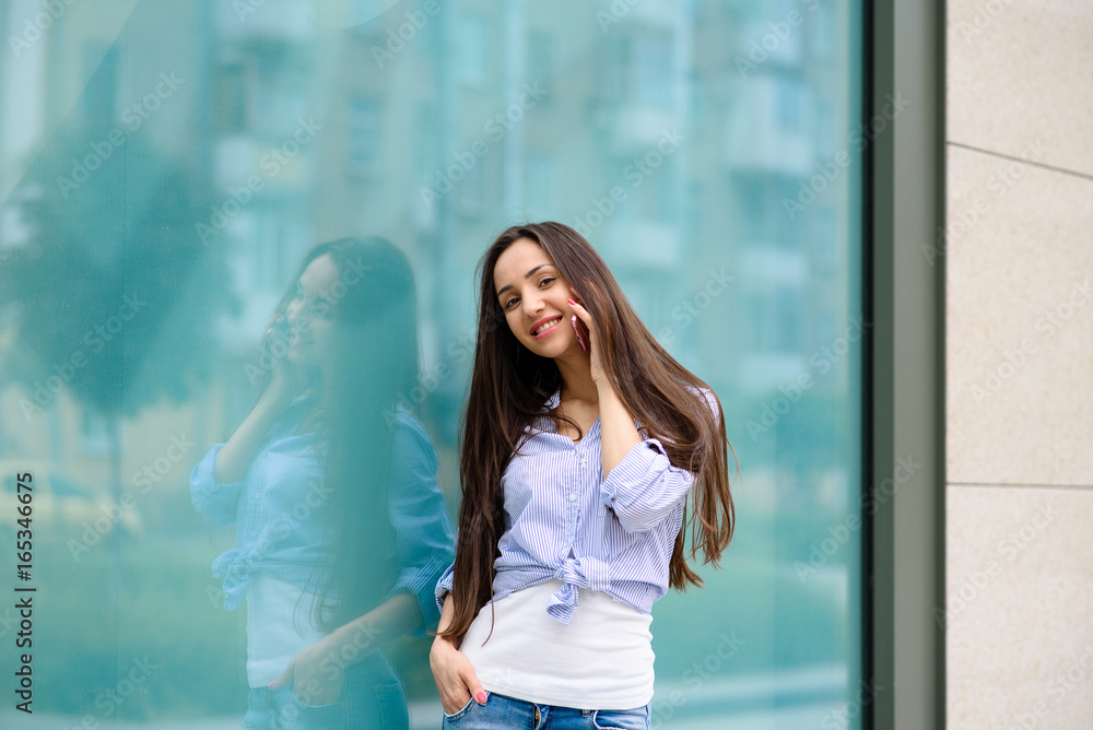 Beautiful girl smiling and talking on the phone. Beautiful girl smiling and talking on the phone.