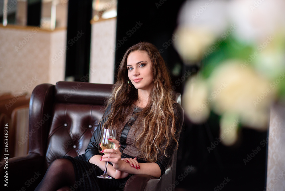 A beautiful girl is drinking champagne in a restaurant. A beautiful girl is drinking champagne in a restaurant.