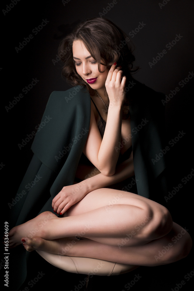 Fototapeta premium Young seductive woman in lace lingerie and warm coat