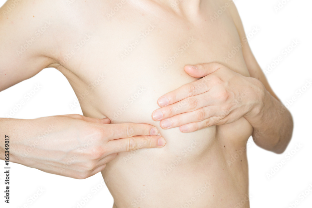 Fototapeta premium Junge, schlanke Frau tastet ihre Brust auf Knoten oder Brustkrebs ab