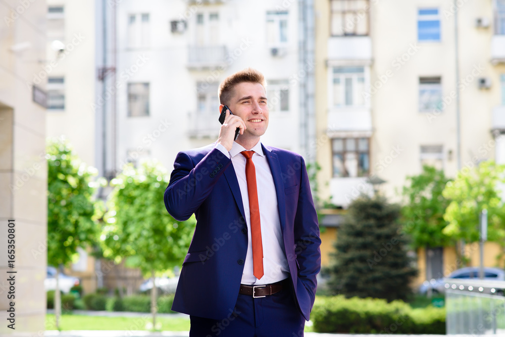 Businessman talking on the phone and smiling. Businessman talking on the phone and smiling.