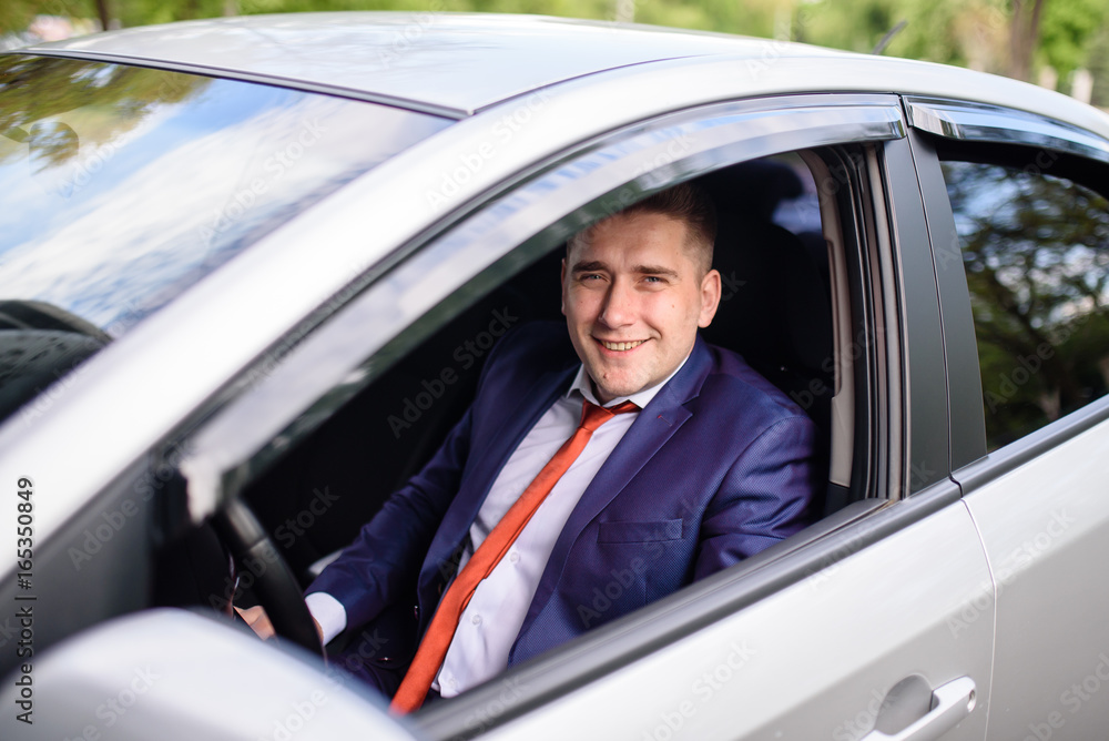 Handsome man smiling in the car.