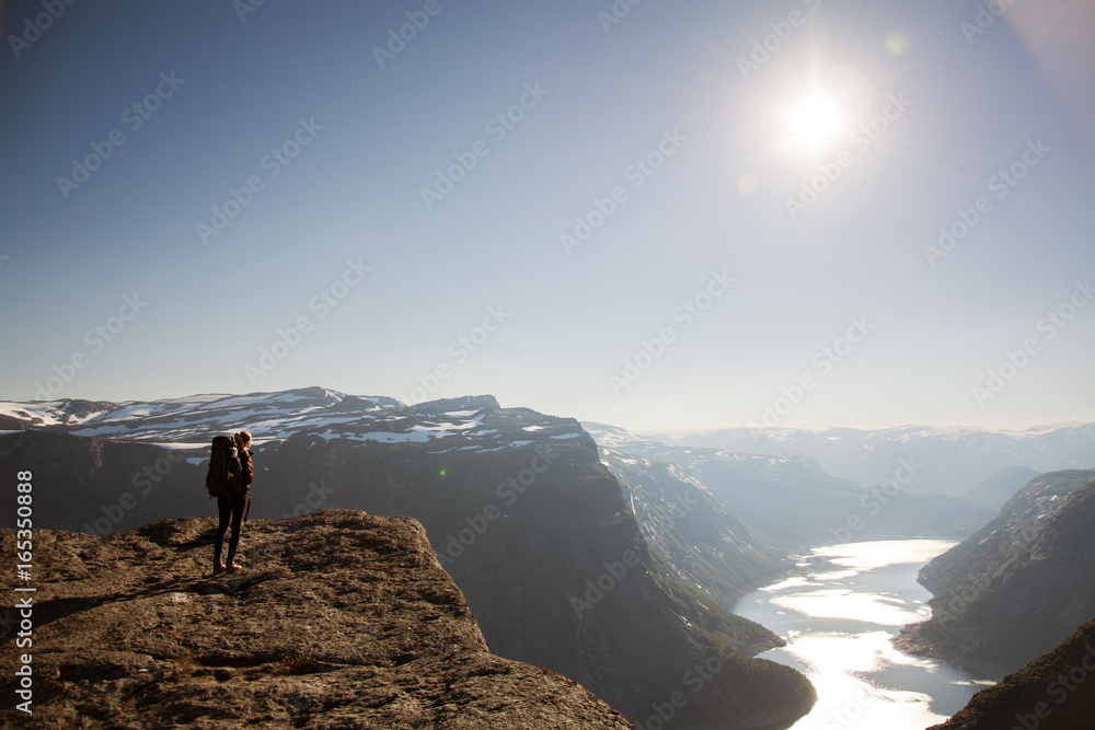 Young backpacker standing at edge of mountain, Norway