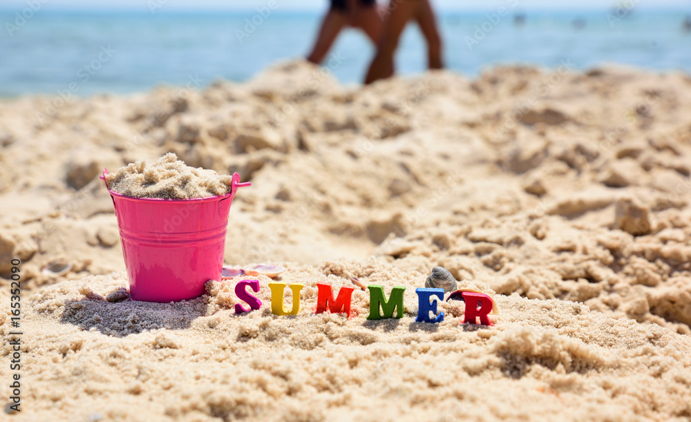 Inscription summer on the sand against the blue sea Inscription summer on the sand against the blue sea