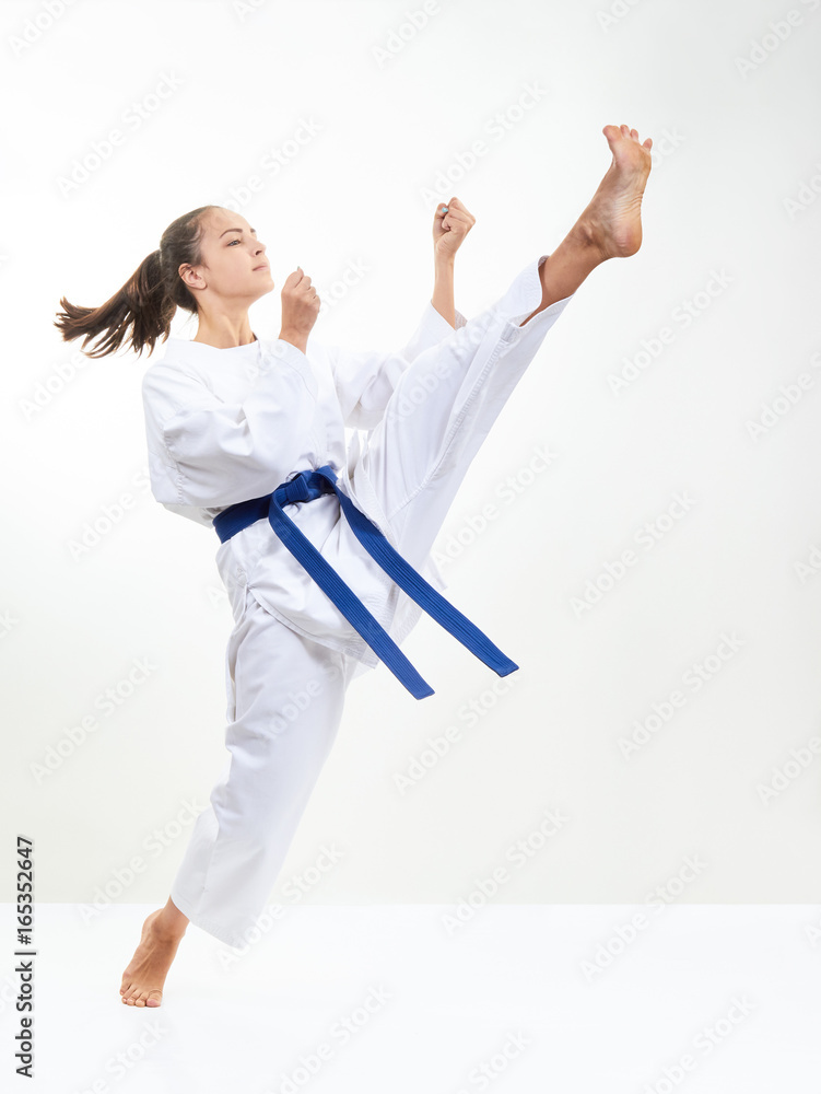 An athlete with a blue belt beats kick leg An athlete with a blue belt beats kick leg