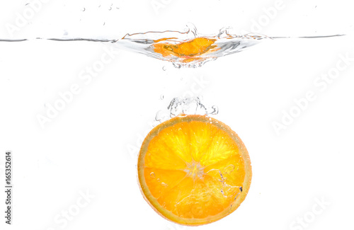 Fototapeta Naklejka Na Ścianę i Meble -  orange slice in water splash on white  background