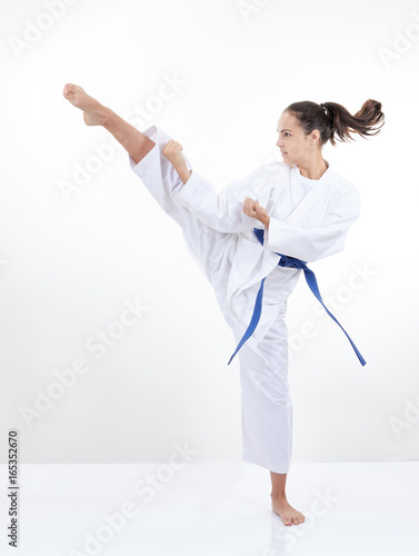High kick kicking girl in karategi