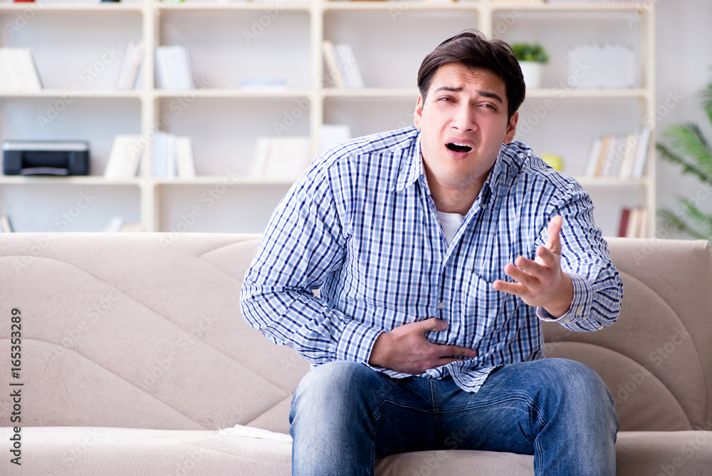 Man suffering from pain at home Man suffering from pain at home