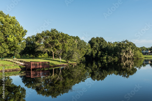 Fishing Dock on Reflective Neighborhood Pond Tampa Florida 