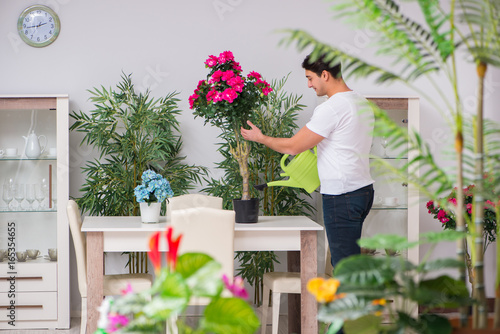 Young man in gardening concept at home