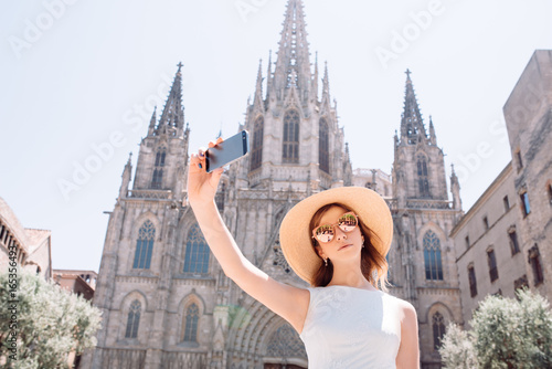 Young female traveler taking self portrayed in Barselona photo