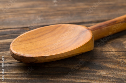 Wooden cooking spoon on wood board or table