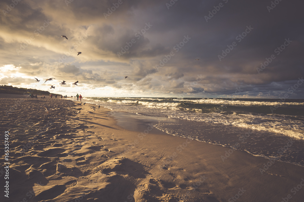 Seascape with dark, dramatic, stormy cumulonimbus cloud formation over the beach at Baltic sea Poland.