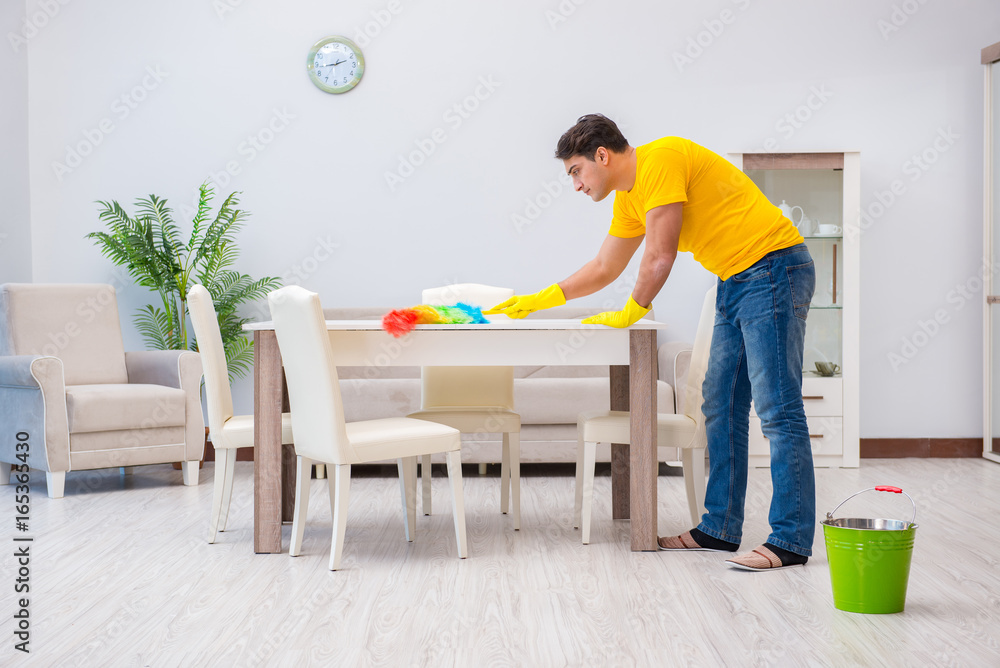 Young man doing chores at home Young man doing chores at home