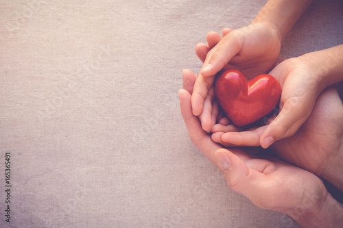Fotografie, Obraz Family hands holding red heart, health care, hope, life insurance concept, world