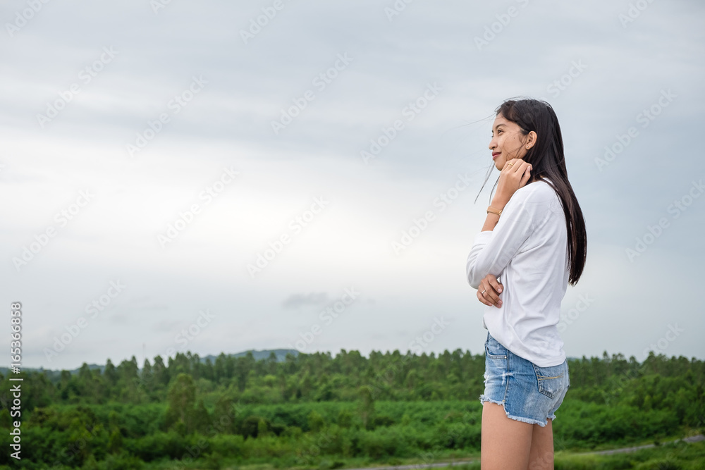 portrait of beautiful young woman standing on the mountain and relaxing portrait of beautiful young woman standing on the mountain and relaxing