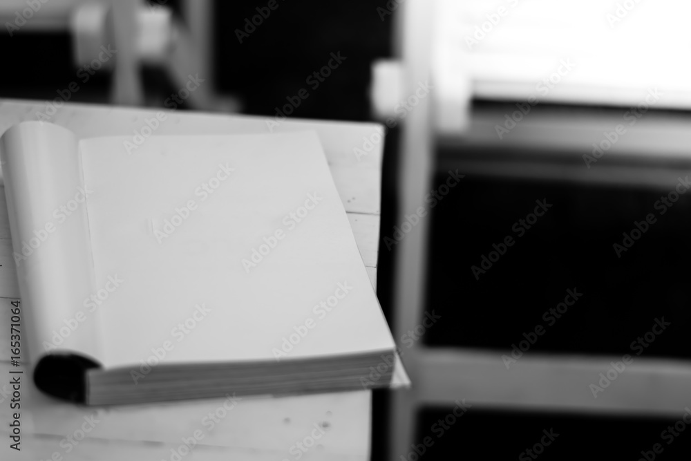Black and white of book on the table in garden with sun light Black and white of book on the table in garden with sun light