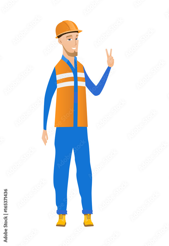 Young caucasian builder showing victory gesture. Young caucasian builder showing victory gesture.