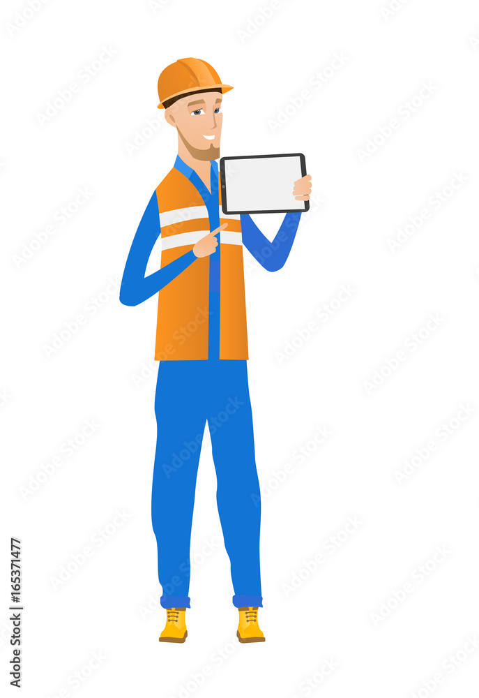 Young caucasian builder holding tablet computer. Young caucasian builder holding tablet computer.