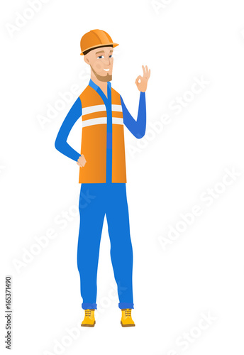 Young caucasian builder showing ok sign.