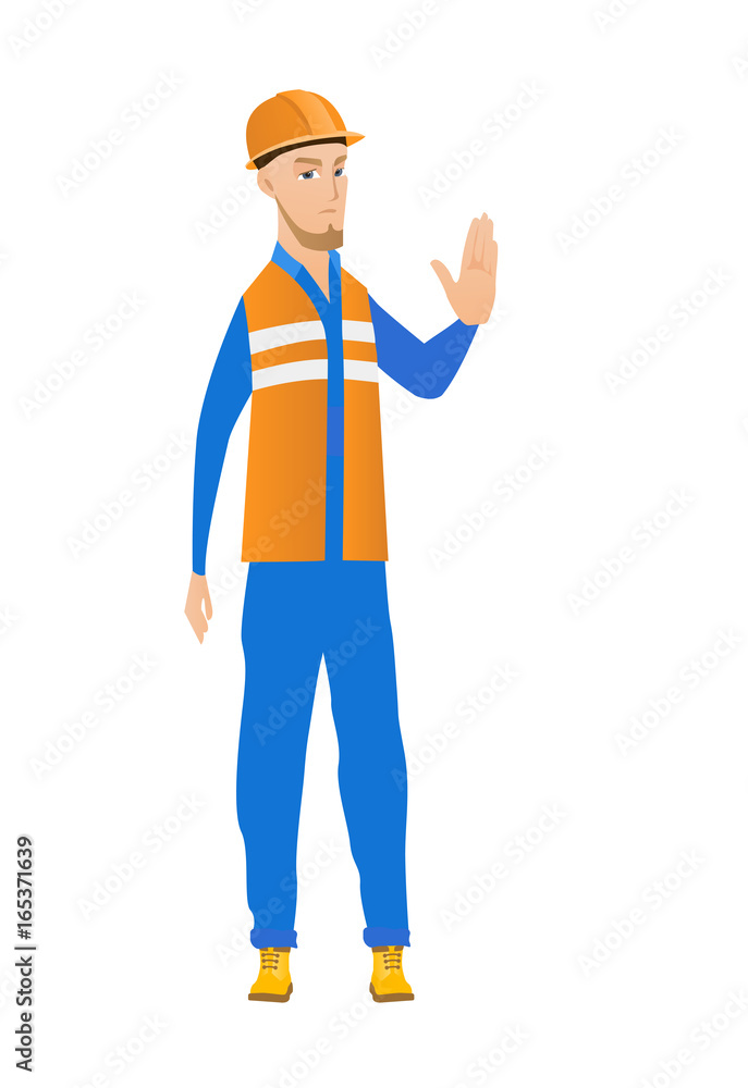 Young caucasian builder showing stop hand gesture