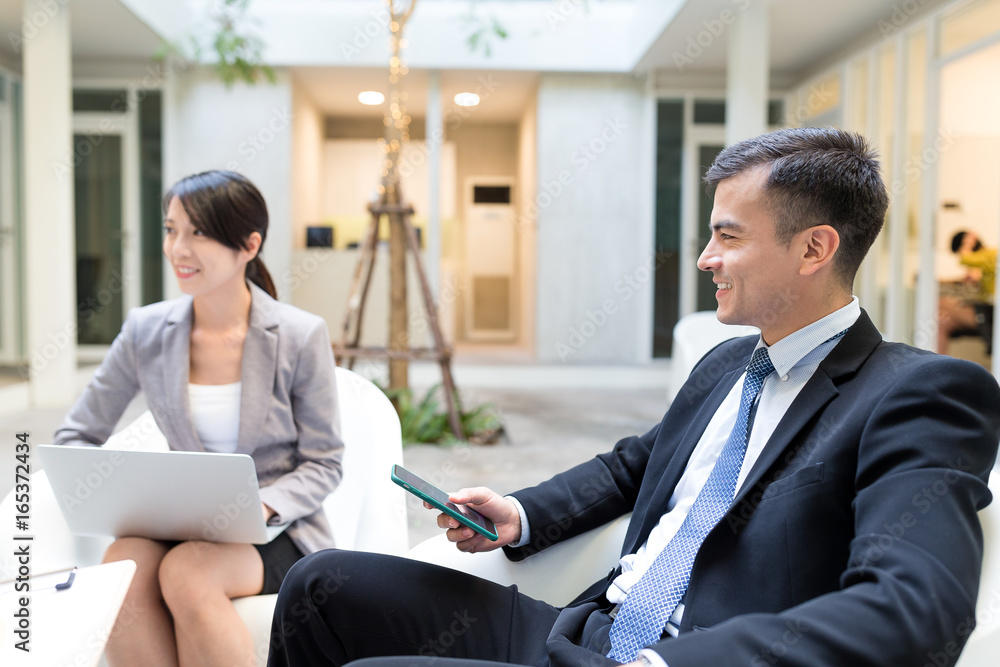 Businessman having discussion with his assistant Businessman having discussion with his assistant