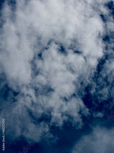 Thin white clouds in blue sky