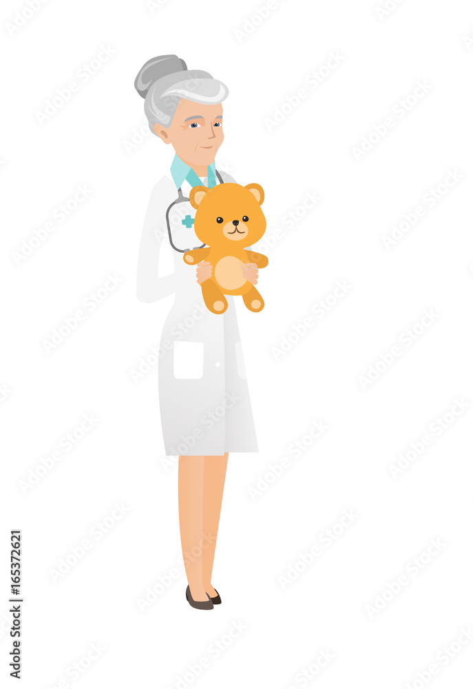 Senior caucasian pediatrician holding teddy bear. Senior caucasian pediatrician holding teddy bear.