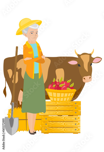 Senior farmer standing with crossed arms near cow.