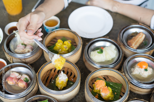 Women's hand hold dim sum. Selective focus.