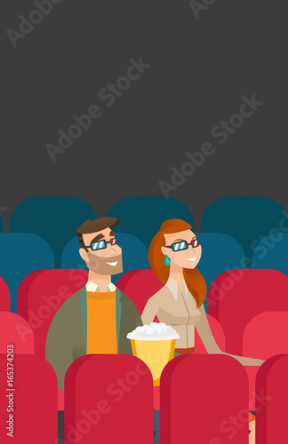 Caucasian couple watching 3D movie in the theatre.