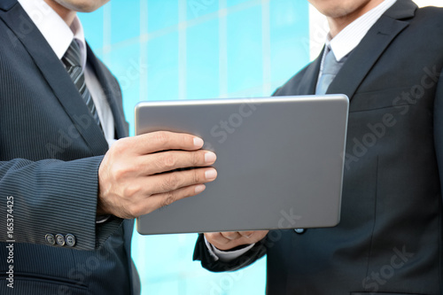 Two businessmen looking at tablet pc