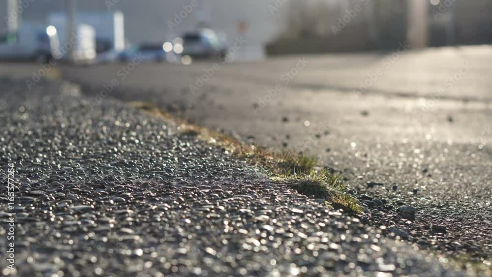 European pebble asphalt street in the morning sun. Car running in small town of Iceland European pebble asphalt street in the morning sun. Car running in small town of Iceland