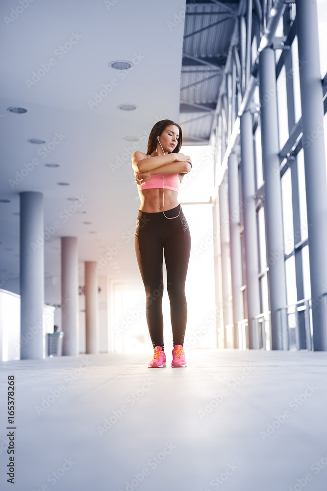 Runner athlete listening to music in headphones from smart phone