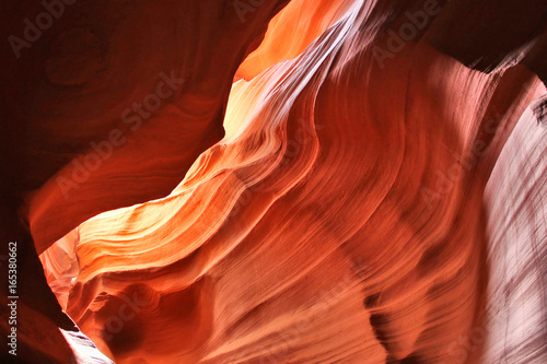 Nature red sandstone textured background. Swirls of old red sandstone wall abstract pattern in Lower Antelope Canyon, Page, Arizona, USA.