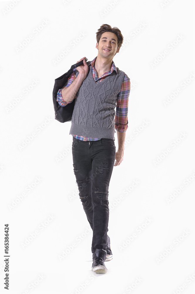 Full portrait of walking man holding handbag in studio Full portrait of walking man holding handbag in studio