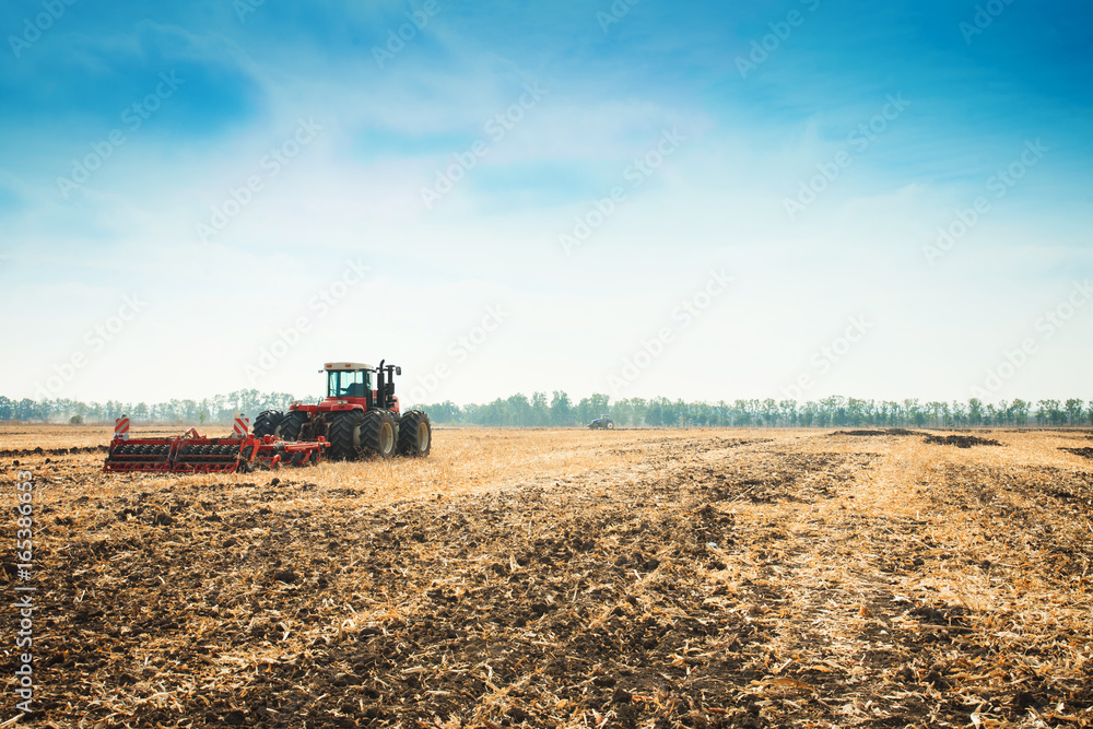 Modern tractor in the field with complex for the plowing. Modern tractor in the field with complex for the plowing.