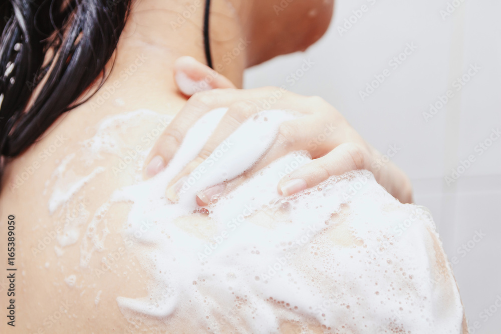 Fototapeta premium Women shower with soap in the bathroom