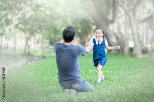 student running into father's hands to hug