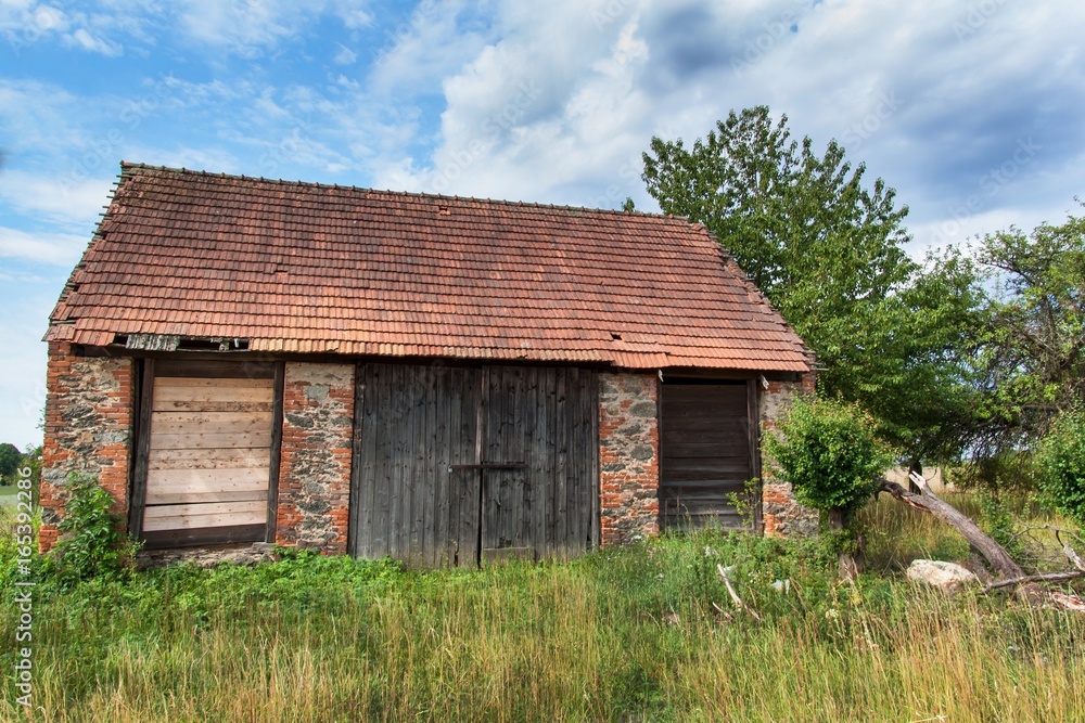 An old abandoned barn in the countryside in the Czech Republic. Summer day at the farm. An old abandoned barn in the countryside in the Czech Republic. Summer day at the farm.