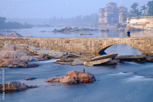 Photographer taking picture of the temples on the bank of Betwa river, Orchha. Long exposure. photo