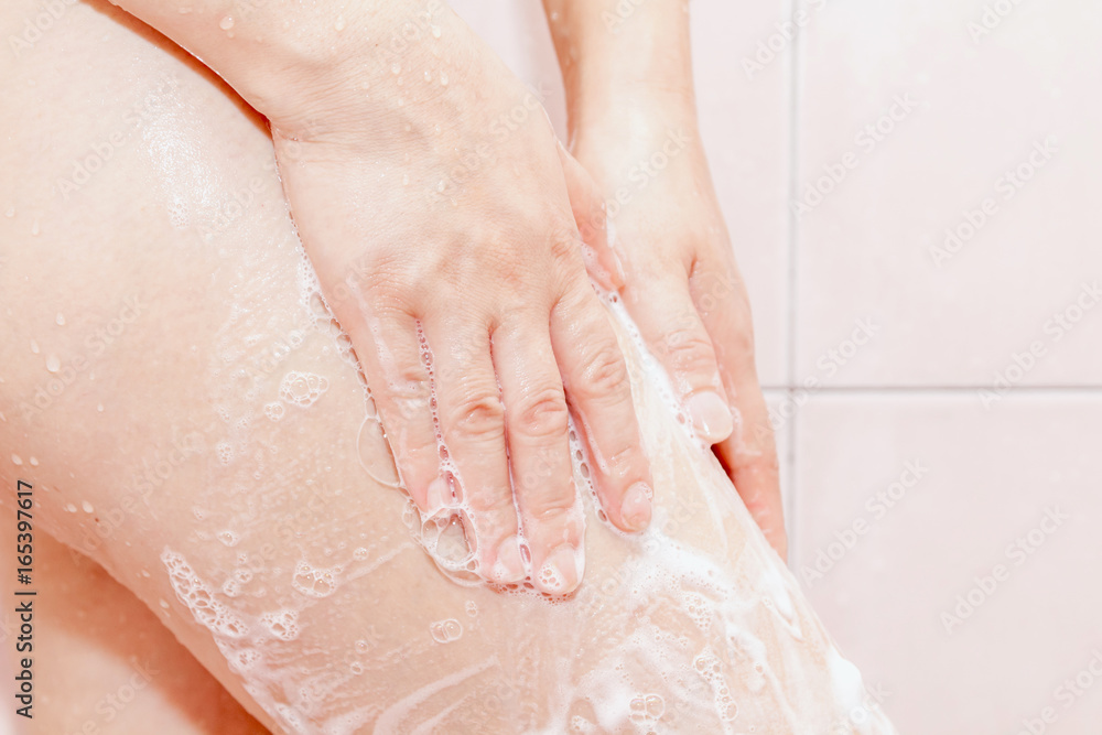 Women shower with soap in the bathroom