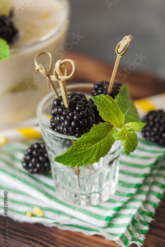 Lemon milkshake garnished with blackberry and mint