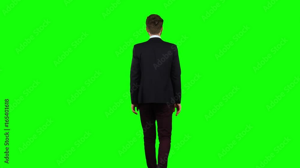 Man is going to a meeting and waving greetings. Green screen. Back view Man is going to a meeting and waving greetings. Green screen. Back view