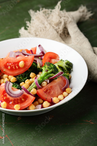 Healthy salad with broccoli and tomato in bowl