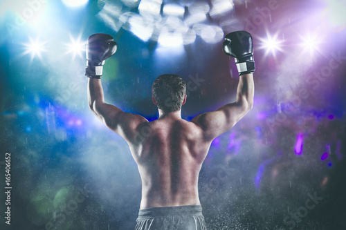 Back view of man boxer with raised hands in victory gesture
