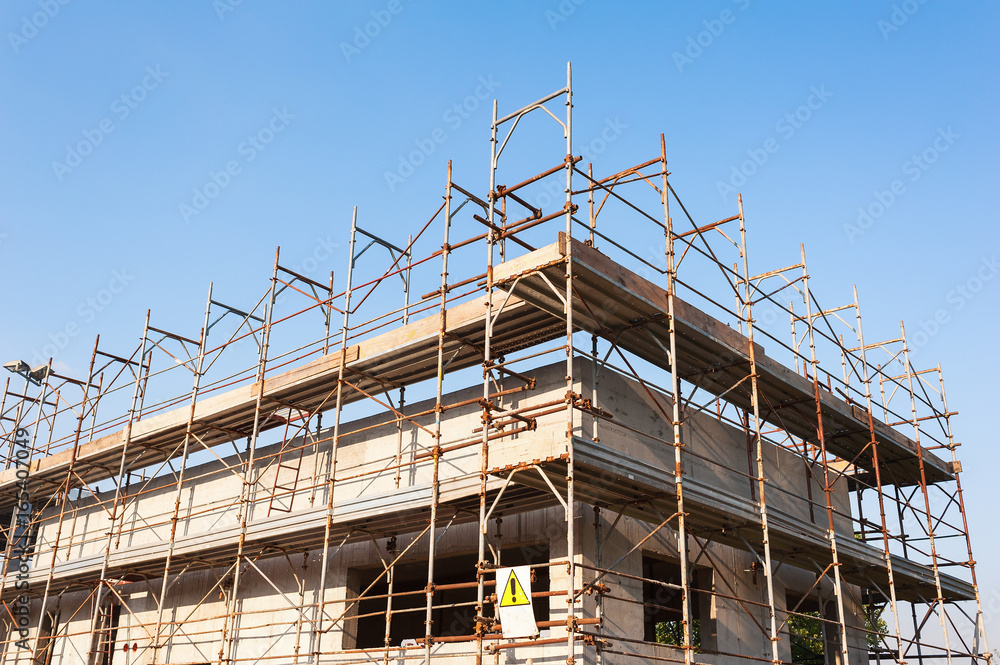 House under construction with scaffolding.