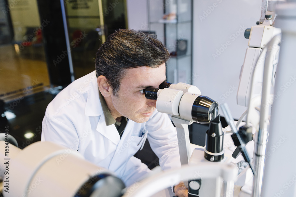 Eye Doctor examinating a young patient Eye Doctor examinating a young patient