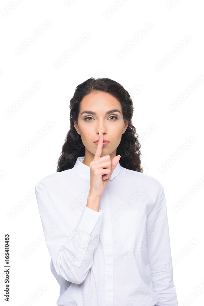 beautiful brunette woman in white shirt showing silence symbol, isolated on white beautiful brunette woman in white shirt showing silence symbol, isolated on white