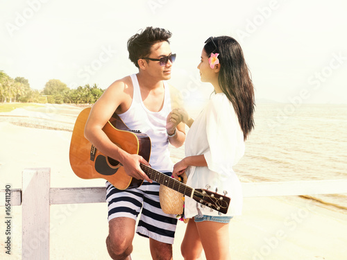 Young couple in love enjoying the time spending and happy together on beach in sunny day, summer holiday, lover concepts. Vintage tone. © Ketsada